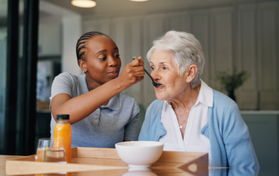 woman feeding elderly