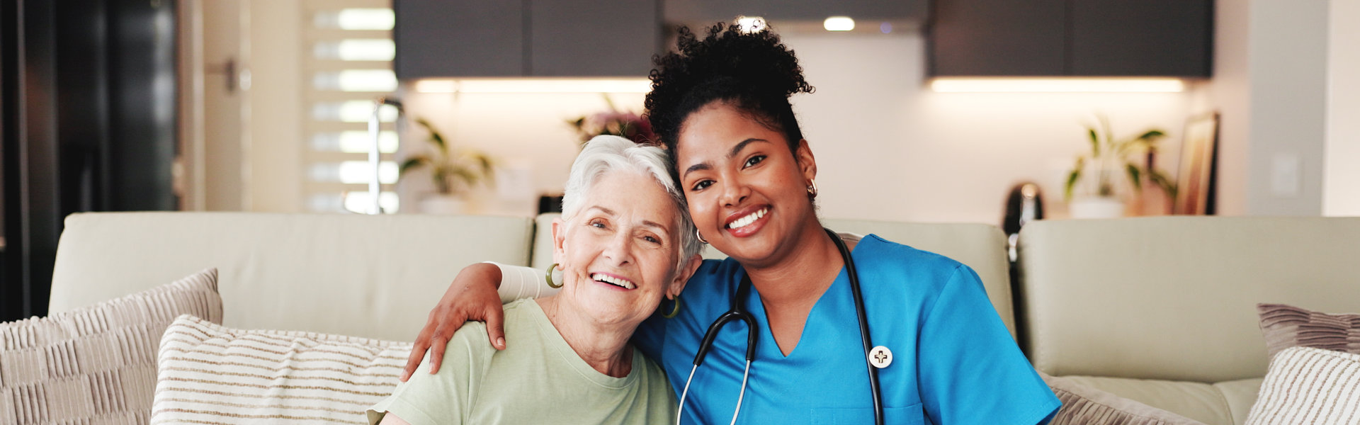 elder woman and nurse smiles together